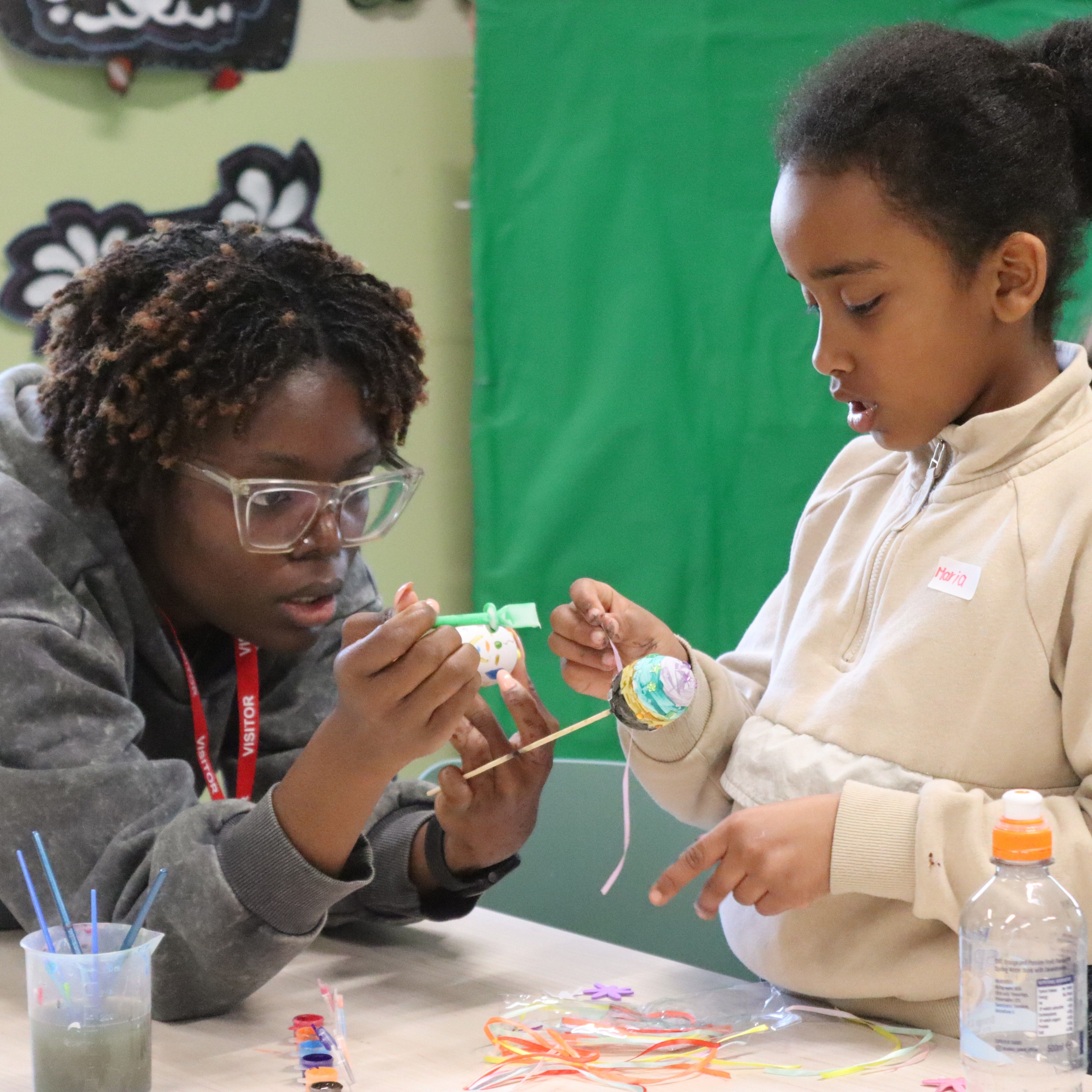 Volunteer crafting with girl